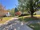 Long driveway leads to a traditional home with a well-manicured front lawn and mature shade trees at 262 Bomar Ln, Douglasville, GA 30134