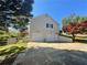 Spacious three-car garage with lots of parking space, surrounded by mature trees and a grassy area at 262 Bomar Ln, Douglasville, GA 30134