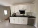 Charming kitchen featuring white cabinets, dark countertops, stainless steel appliances and tile backsplash at 262 Bomar Ln, Douglasville, GA 30134