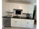 Charming kitchen featuring white cabinets and stainless steel dishwasher and sink at 262 Bomar Ln, Douglasville, GA 30134
