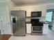 Well-lit kitchen featuring stainless steel appliances and white cabinetry at 262 Bomar Ln, Douglasville, GA 30134