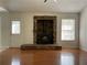 Bright living room featuring wood floors and a stone fireplace with wood-burning stove at 262 Bomar Ln, Douglasville, GA 30134
