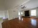 Open concept living room featuring hardwood floors, modern ceiling fan, and brick fireplace at 262 Bomar Ln, Douglasville, GA 30134