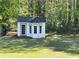 Charming white outbuilding with a turret roof and several windows, set in a well-manicured lawn at 262 Bomar Ln, Douglasville, GA 30134