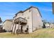 Exterior view of a two-story home with a wooden balcony and a sloping backyard at 4604 Marching Ln, Fairburn, GA 30213