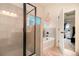 Bathroom featuring a glass shower, a soaking tub, and decorative wall art at 4604 Marching Ln, Fairburn, GA 30213