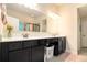 Bathroom featuring cabinets with storage and a large mirror above the vanity at 4604 Marching Ln, Fairburn, GA 30213
