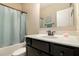 The bathroom features a black vanity, a mirror, and a shower with a blue shower curtain at 4604 Marching Ln, Fairburn, GA 30213