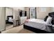 This bedroom has a bed with a black headboard and a large mirror at 4604 Marching Ln, Fairburn, GA 30213