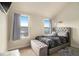 The bedroom features two windows and a bed with a tufted headboard at 4604 Marching Ln, Fairburn, GA 30213