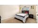 A bedroom has carpet and a bed with a black headboard at 4604 Marching Ln, Fairburn, GA 30213
