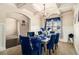 Formal dining room with a chandelier, elegant blue decor, and wainscoting, perfect for entertaining at 4604 Marching Ln, Fairburn, GA 30213