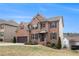 A well-maintained brick home showcasing a beautiful lawn, two-car garage, and classic design elements at 4604 Marching Ln, Fairburn, GA 30213