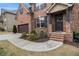 Inviting entryway with a brick walkway, decorative wreath, and a charming 