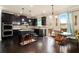 Modern kitchen featuring dark cabinets, granite countertops, stainless steel appliances, and an eat-in area at 4604 Marching Ln, Fairburn, GA 30213
