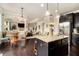 Open-concept kitchen with a view of the living room and an island with seating at 4604 Marching Ln, Fairburn, GA 30213