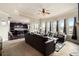 Inviting living area with large windows, comfortable seating, and an open layout to the modern kitchen at 4604 Marching Ln, Fairburn, GA 30213