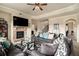 Cozy living room featuring a stone fireplace, plush sofas, and a patterned area rug at 4604 Marching Ln, Fairburn, GA 30213