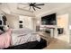Comfortable main bedroom with a ceiling fan and a view of the ensuite bathroom at 4604 Marching Ln, Fairburn, GA 30213