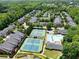 Community aerial view featuring tennis courts, pool, and lush green landscaping at 4900 Fairmont Way, Roswell, GA 30075