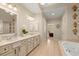 The bathroom features a soaking tub, double vanities, and neutral tile flooring, creating a serene atmosphere at 4900 Fairmont Way, Roswell, GA 30075
