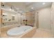 Bathroom boasts a jacuzzi tub, glass shower enclosure, and double vanity with stone tile flooring at 4900 Fairmont Way, Roswell, GA 30075