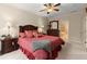 Spacious bedroom featuring plush carpet, a ceiling fan, and a doorway to a bathroom at 4900 Fairmont Way, Roswell, GA 30075