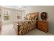 Comfortable bedroom features a classic wooden bed frame and bright natural light from the two windows at 4900 Fairmont Way, Roswell, GA 30075