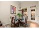 Cozy breakfast nook with glass table, decorative chandelier, and view to the outdoors at 4900 Fairmont Way, Roswell, GA 30075