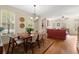 The dining room features hardwood floors, a chandelier, and flows into the living area, perfect for entertaining at 4900 Fairmont Way, Roswell, GA 30075