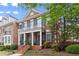 Charming brick townhouse with a cozy porch, second-floor balcony, and well-manicured landscaping at 4900 Fairmont Way, Roswell, GA 30075
