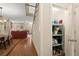 Open hallway with hardwood floors transitions to the dining and living room featuring a pantry at 4900 Fairmont Way, Roswell, GA 30075