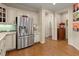 Spacious kitchen featuring stainless steel refrigerator, hardwood floors, and light colored cabinets at 4900 Fairmont Way, Roswell, GA 30075