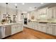 Modern kitchen featuring stainless steel appliances, an island, light countertops, and hardwood floors at 4900 Fairmont Way, Roswell, GA 30075