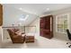 Loft with leather chair, natural light, and a dark wood cabinet at 4900 Fairmont Way, Roswell, GA 30075