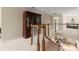 Second floor landing with hardwood railing, carpet flooring, and a view of the living room at 4900 Fairmont Way, Roswell, GA 30075