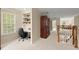 Second floor landing featuring a built-in desk, hardwood railing, and a decorative cabinet at 4900 Fairmont Way, Roswell, GA 30075