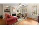 Bright living room with a fireplace, built-in shelves, and a door to the outside at 4900 Fairmont Way, Roswell, GA 30075