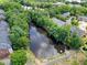 Aerial view of the community pond surrounded by lush greenery at 4900 Fairmont Way, Roswell, GA 30075