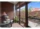 Cozy sunroom with brick walls, rocking chairs, and a view of the private backyard at 4900 Fairmont Way, Roswell, GA 30075