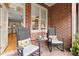 Enclosed sunroom featuring brick walls and rocking chairs at 4900 Fairmont Way, Roswell, GA 30075