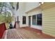 View of the deck with wood flooring and door to the house and view of the wooded backyard at 100 Julia Ct, Fayetteville, GA 30214