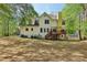 Spacious backyard view showcasing the deck, mature trees and lawn at 100 Julia Ct, Fayetteville, GA 30214