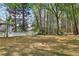 View of the mature trees and white fence in the backyard at 100 Julia Ct, Fayetteville, GA 30214