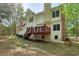 Home exterior and backyard with mature trees, deck and walkout basement at 100 Julia Ct, Fayetteville, GA 30214