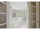 Bathroom with a tub and shower behind beautiful french doors at 100 Julia Ct, Fayetteville, GA 30214