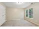 Carpeted bedroom features a window view at 100 Julia Ct, Fayetteville, GA 30214