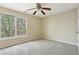 Bedroom with neutral walls, carpet flooring, ceiling fan, and a window at 100 Julia Ct, Fayetteville, GA 30214
