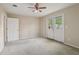 Spacious bedroom features carpeted floor, ceiling fan, and direct access to backyard at 100 Julia Ct, Fayetteville, GA 30214