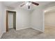 Neutral bedroom features plush carpet, ceiling fan, and closet at 100 Julia Ct, Fayetteville, GA 30214